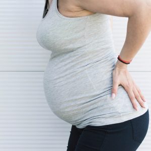 pregnant woman holding hips