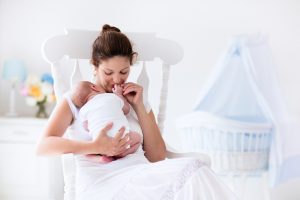 young mother holding newborn baby