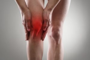 women holding sore knee